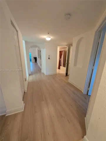 a kitchen with white cabinets appliances and a sink