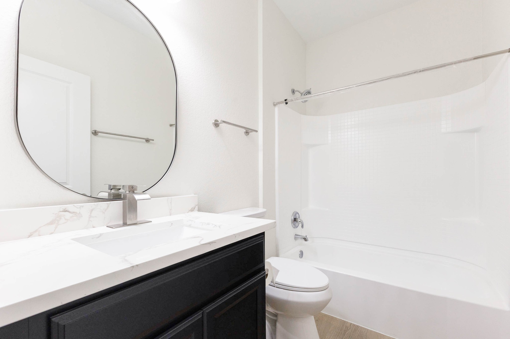331 Seneca Loop Kyle, TX 78640 - Photo 19 of 29 The first floor full bath conveniently serves the first floor bedroom and guests, finished with a modern oval mirror and tub/shower combo.