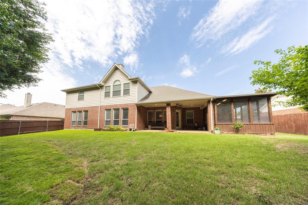 220 Justin Road Murphy, TX 75094 - Photo 37 of 40 Back of property featuring a sunroom, a ceiling fan, brick siding, and a chimney