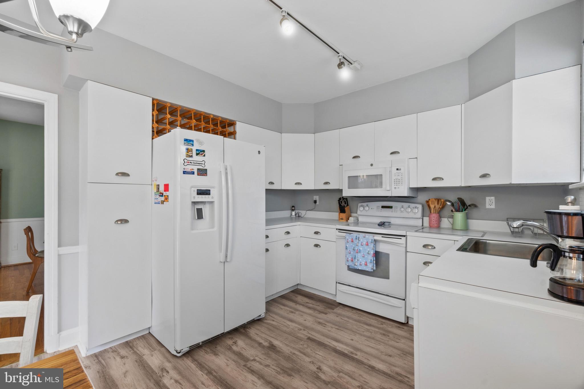 909 Weatherbee Road Towson, MD 21286 - Photo 16 of 51 a kitchen with cabinets appliances and wooden floor