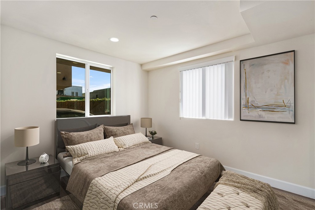 1822 Orchard Avenue, Unit 1822 Los Angeles, CA 90006 - Photo 11 of 17 a bedroom with a bed and a window