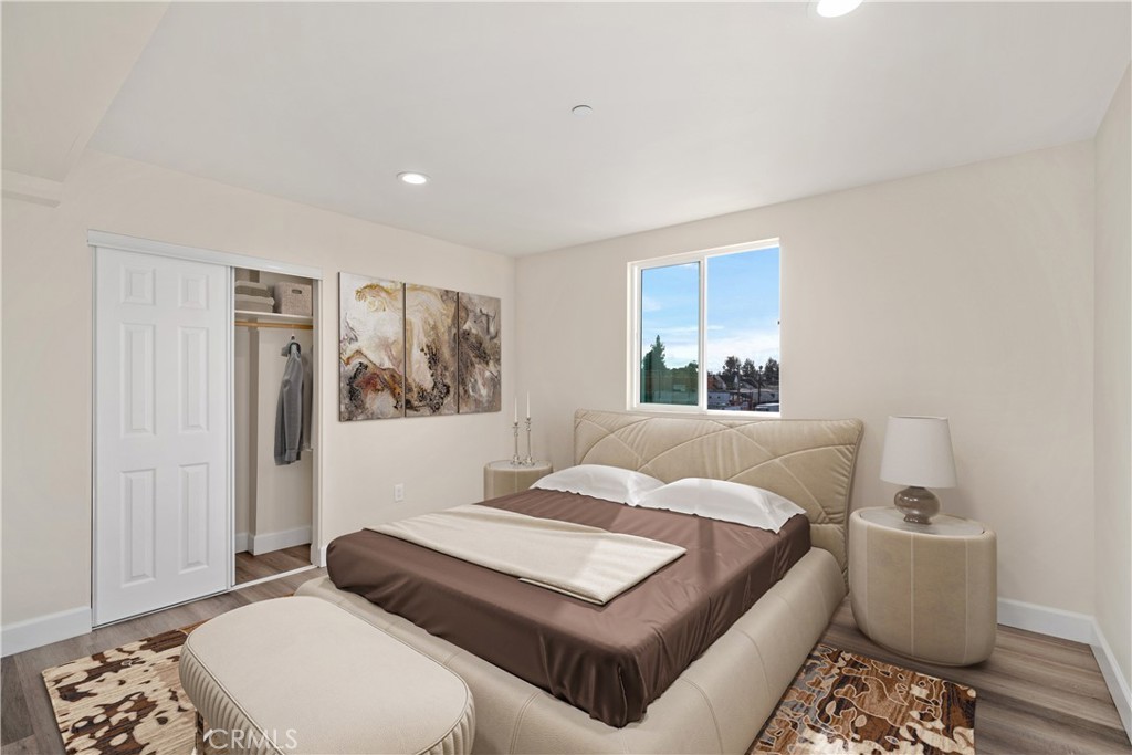 1822 Orchard Avenue, Unit 1822 Los Angeles, CA 90006 - Photo 13 of 17 a bedroom with a large bed and a window
