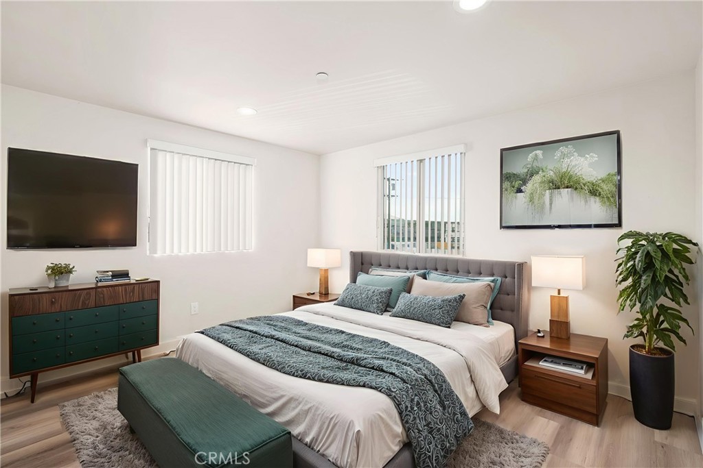 1822 Orchard Avenue, Unit 1822 Los Angeles, CA 90006 - Photo 15 of 17 a bedroom with a bed and a flat screen tv