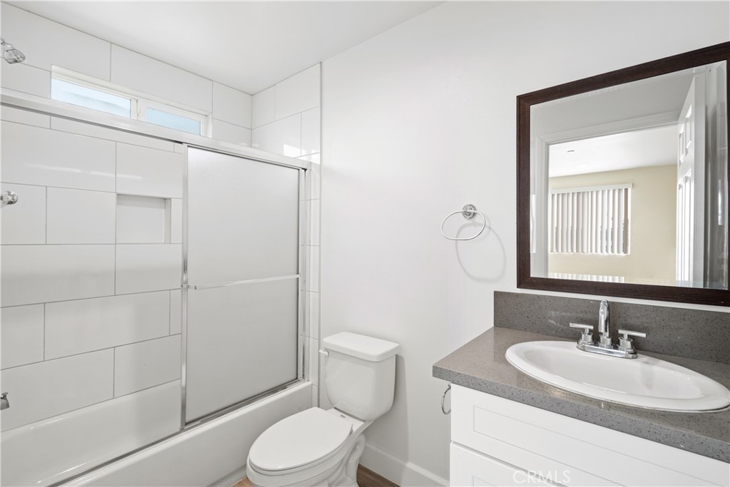 1822 Orchard Avenue, Unit 1822 Los Angeles, CA 90006 - Photo 16 of 17 a bathroom with a sink toilet and shower