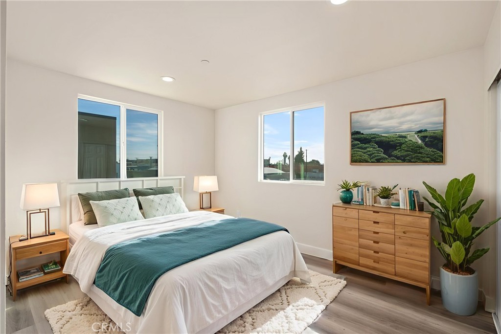 1822 Orchard Avenue, Unit 1822 Los Angeles, CA 90006 - Photo 9 of 17 a bedroom with a large bed and a potted plant