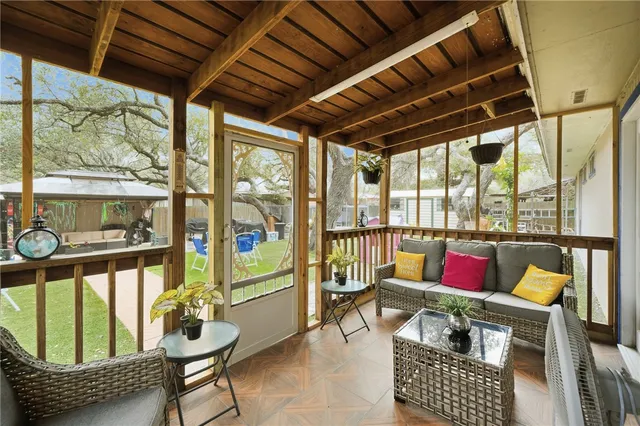 a roof deck with couch and chairs