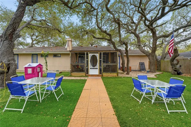 a front view of a house with a yard table and chairs