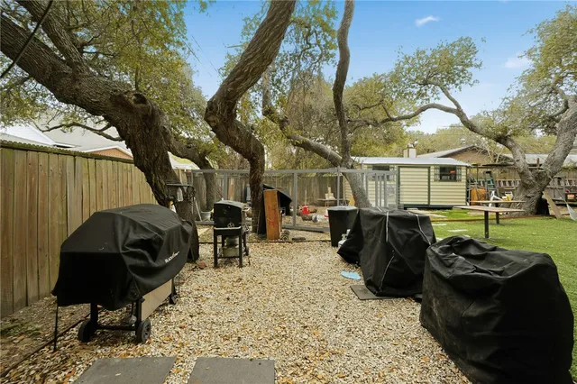 a view of a chairs and tables in the back yard of the house