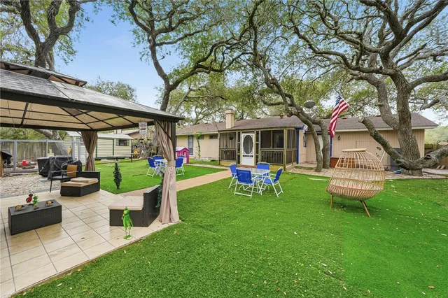a view of a house with backyard porch and sitting area