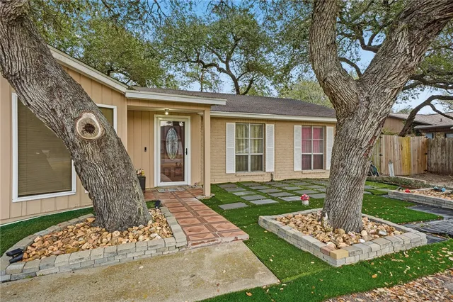 a front view of a house with garden