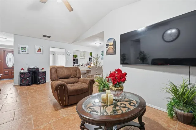 a living room with furniture and flowers