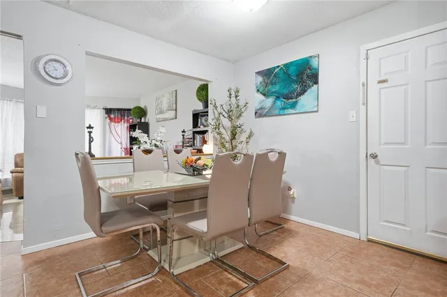 a view of a dining room with furniture and a window