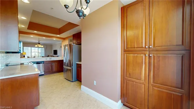 a kitchen with refrigerator and cabinets