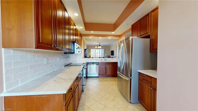 a kitchen with stainless steel appliances granite countertop cabinets and refrigerator