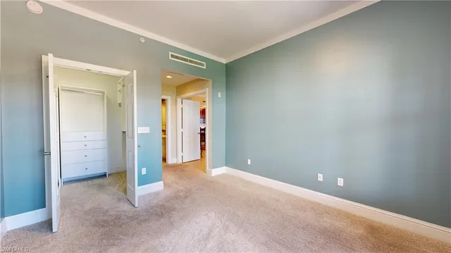 an empty room with closet and a bathroom