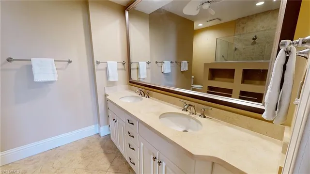a spacious bathroom with a granite countertop sink a toilet and shower