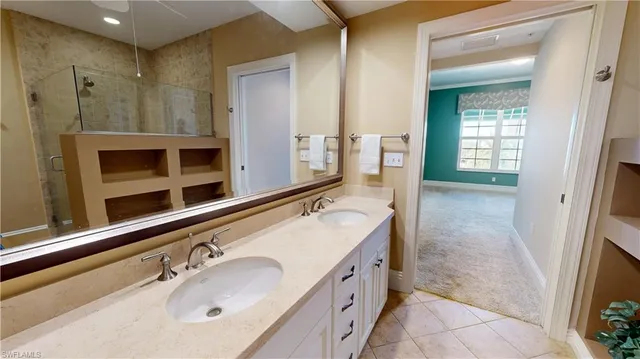 a bathroom with a granite countertop sink mirror and shower