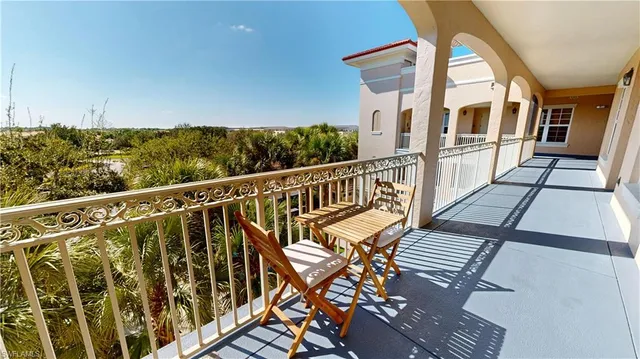 a view of a wooden chairs on the roof deck