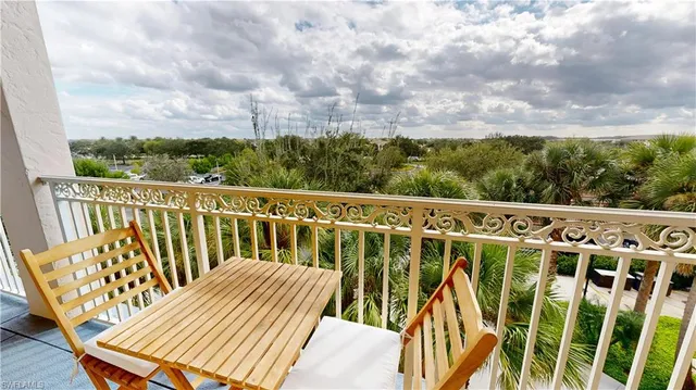 a view of a swimming pool with outdoor seating