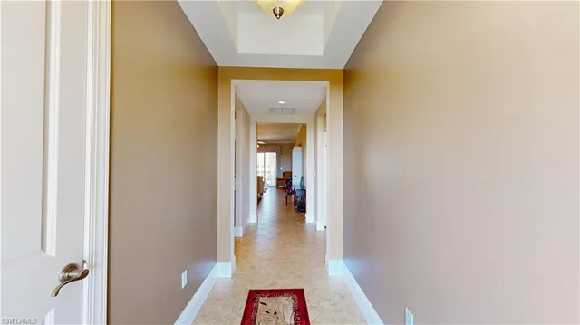 a view of a hallway view with wooden floor and a bathroom