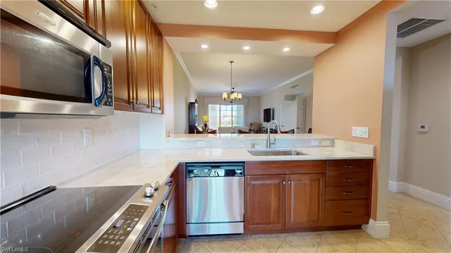 a kitchen with cabinets and stainless steel appliances