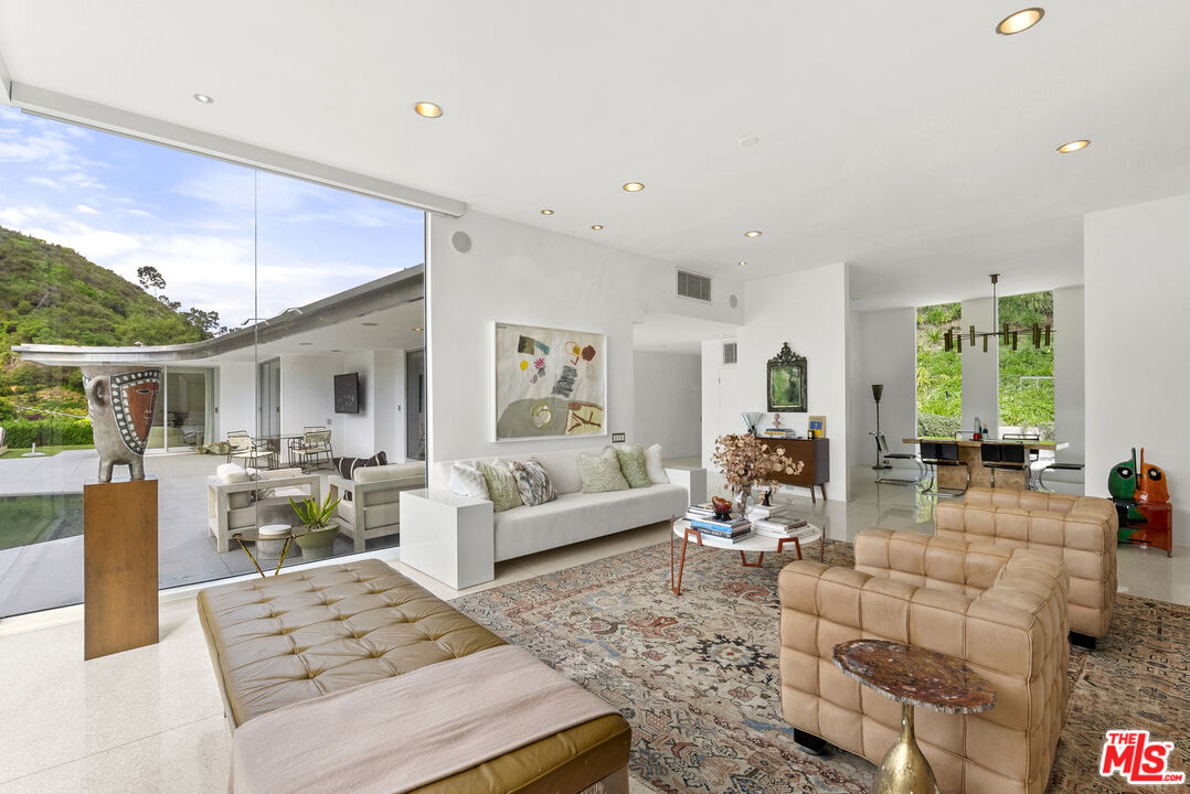 10899 Chalon Road Los Angeles, CA 90077 - Photo 12 of 34 a living room with furniture and a large window
