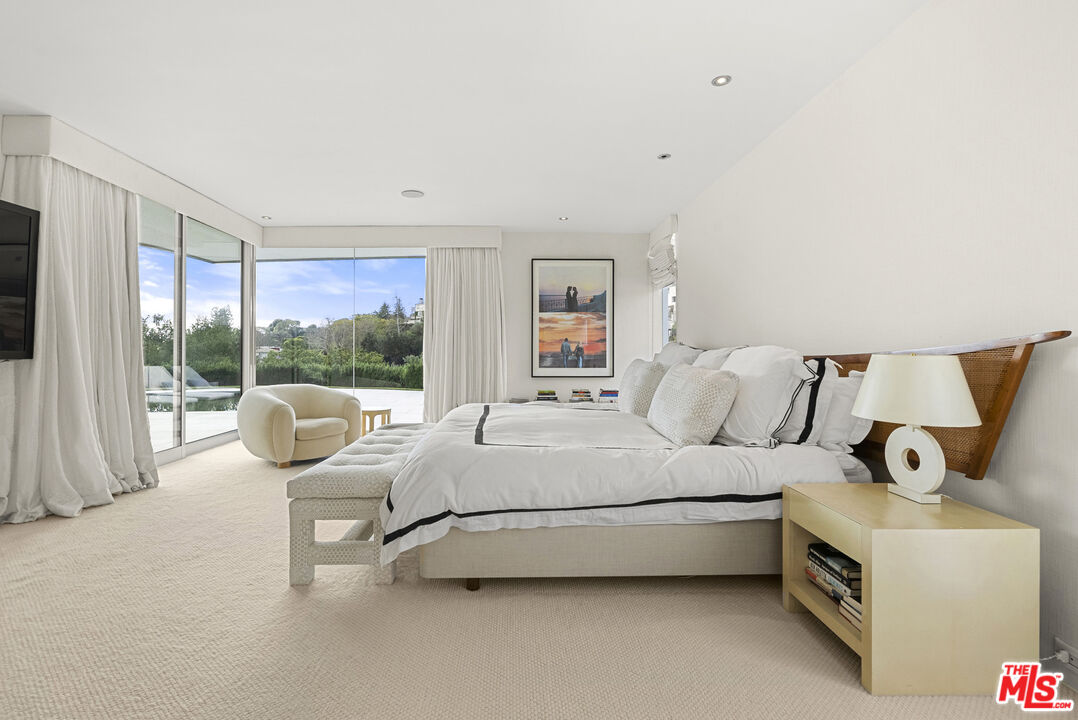 10899 Chalon Road Los Angeles, CA 90077 - Photo 17 of 34 a bedroom with bed and a large window