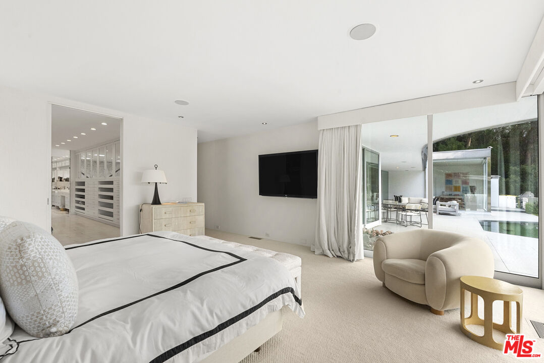 10899 Chalon Road Los Angeles, CA 90077 - Photo 19 of 34 a living room with furniture and a flat screen tv