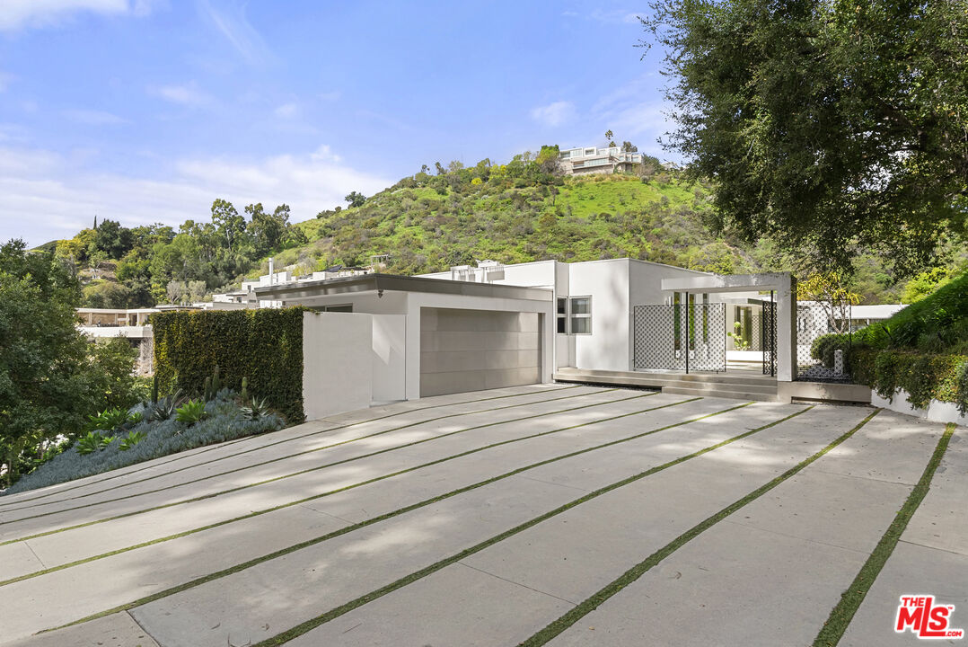 10899 Chalon Road Los Angeles, CA 90077 - Photo 2 of 34 a view of a house with a patio