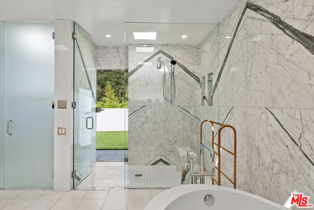 10899 Chalon Road Los Angeles, CA 90077 - Photo 21 of 34 a bathroom with a bathtub and a shower
