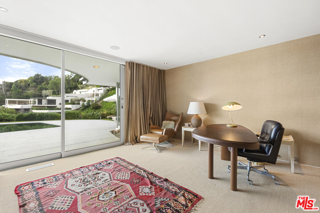 10899 Chalon Road Los Angeles, CA 90077 - Photo 22 of 34 a living room with furniture and a rug