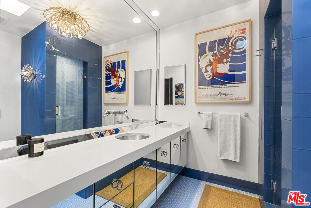10899 Chalon Road Los Angeles, CA 90077 - Photo 23 of 34 a bathroom with double vanity sink and a mirror