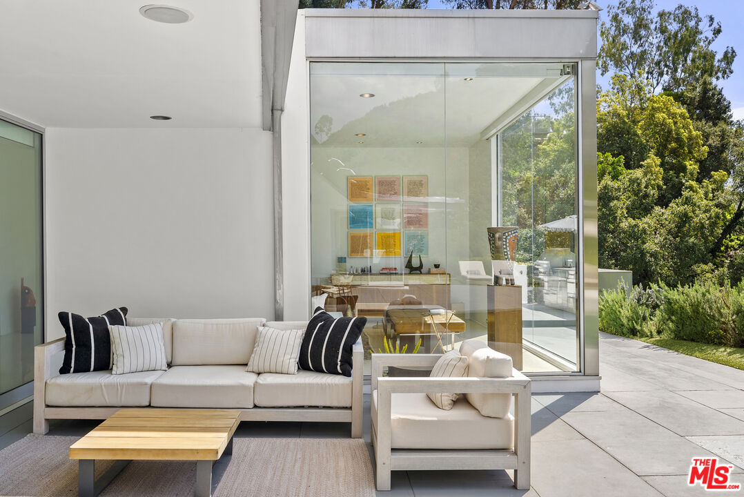 10899 Chalon Road Los Angeles, CA 90077 - Photo 27 of 34 a living room with furniture and a large window