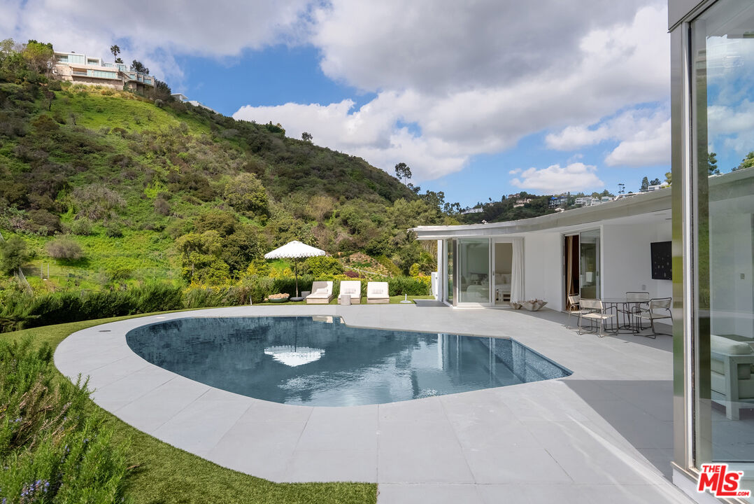 10899 Chalon Road Los Angeles, CA 90077 - Photo 29 of 34 a view of outdoor space yard and swimming pool
