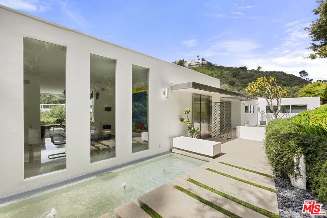10899 Chalon Road Los Angeles, CA 90077 - Photo 3 of 34 front view of a house with a outdoor space