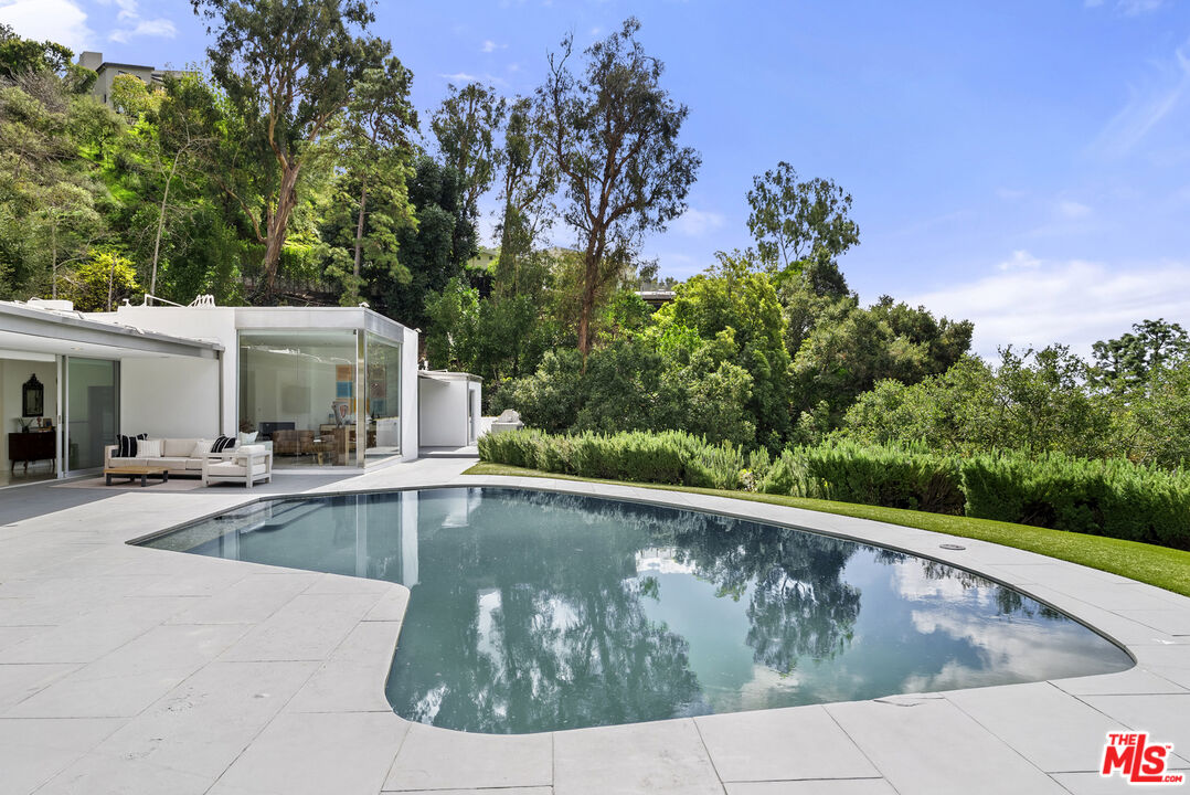 10899 Chalon Road Los Angeles, CA 90077 - Photo 32 of 34 a view of a swimming pool with a patio