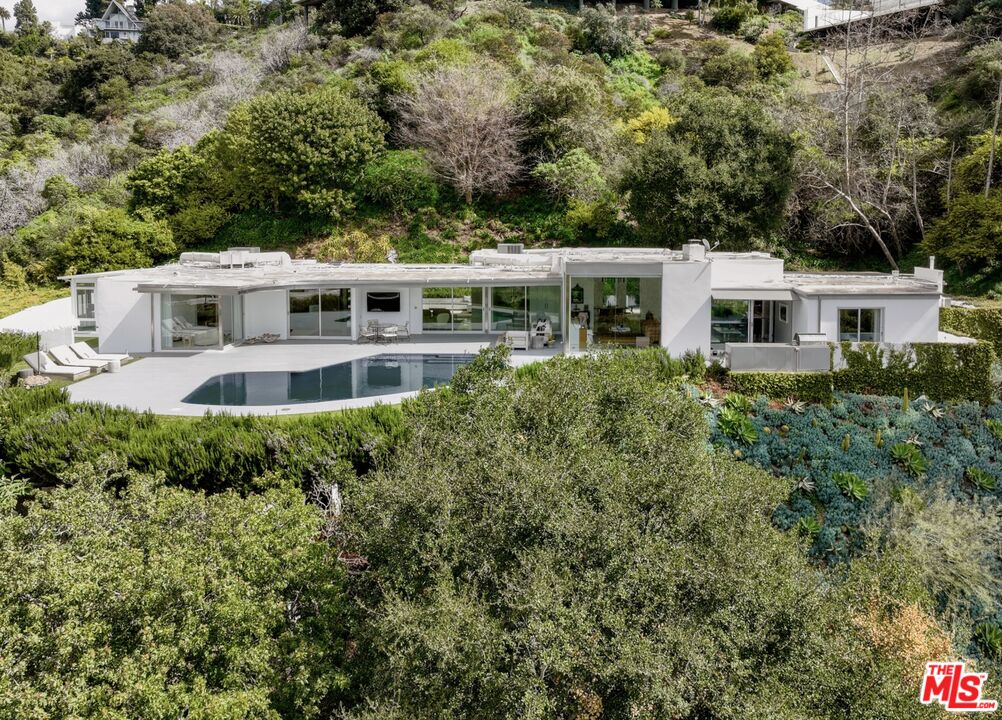 10899 Chalon Road Los Angeles, CA 90077 - Photo 33 of 34 front view of a house with a yard