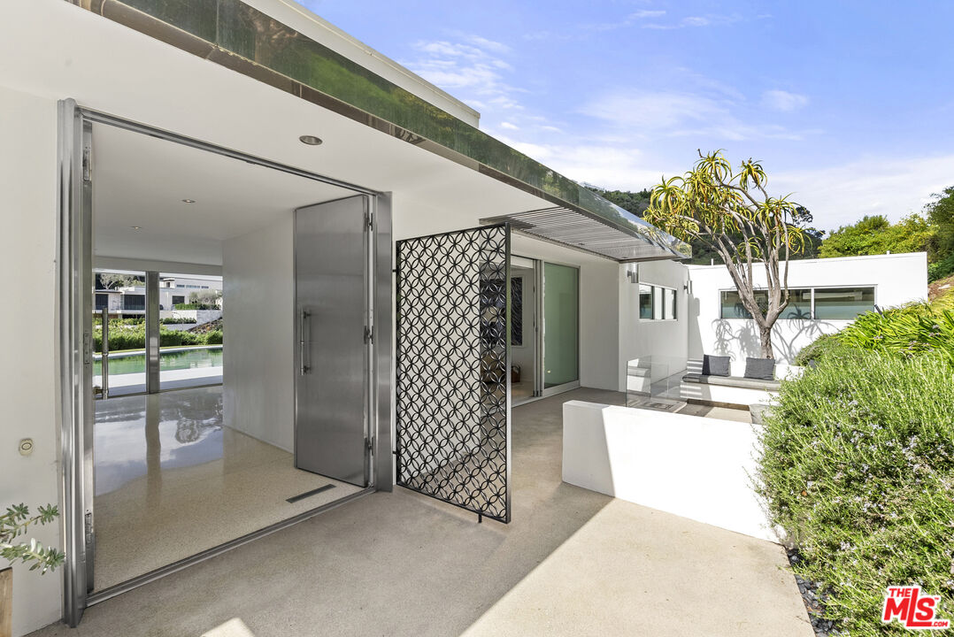 10899 Chalon Road Los Angeles, CA 90077 - Photo 4 of 34 a view of a house with a outdoor space