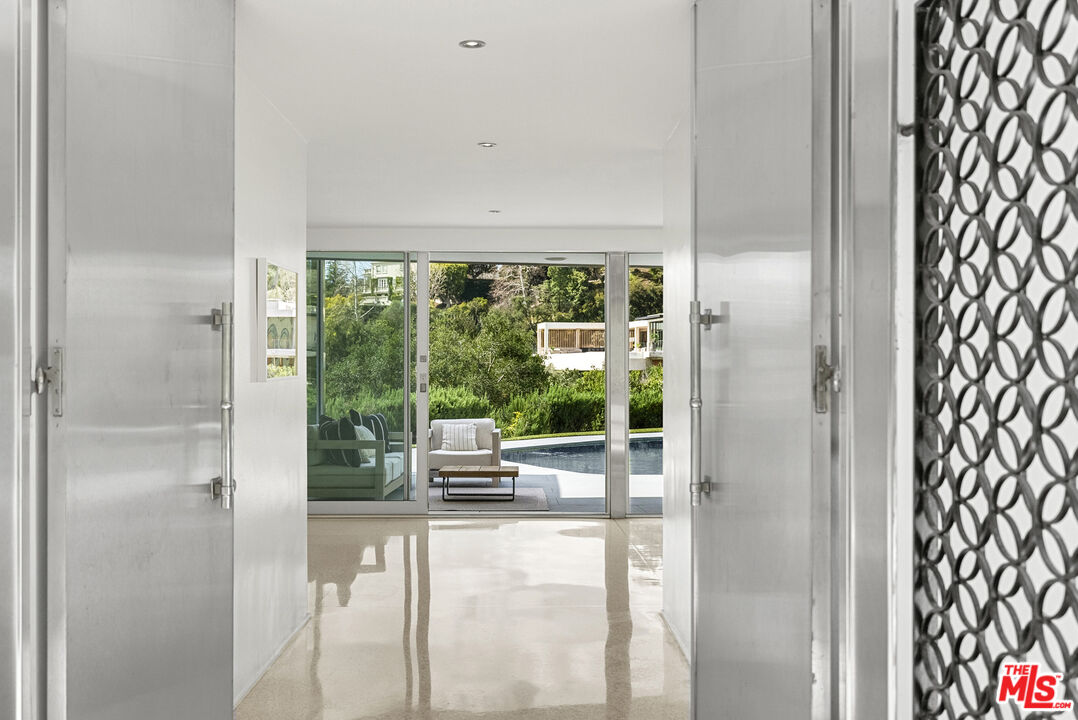 10899 Chalon Road Los Angeles, CA 90077 - Photo 5 of 34 a living room with a floor to ceiling window and floor to ceiling window