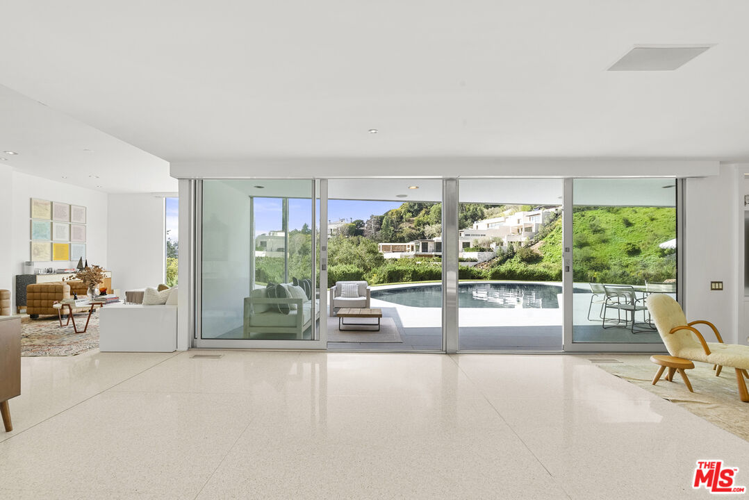 10899 Chalon Road Los Angeles, CA 90077 - Photo 6 of 34 a view of a livingroom with furniture and floor to ceiling window