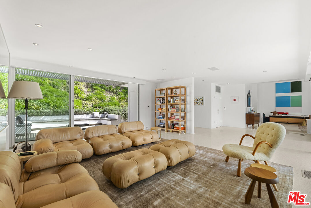 10899 Chalon Road Los Angeles, CA 90077 - Photo 7 of 34 a living room with furniture and a large window