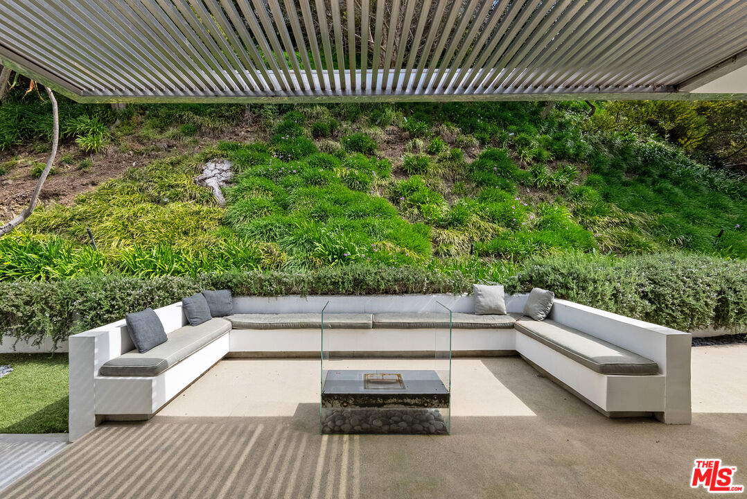 10899 Chalon Road Los Angeles, CA 90077 - Photo 8 of 34 a view of a patio with a table and chairs