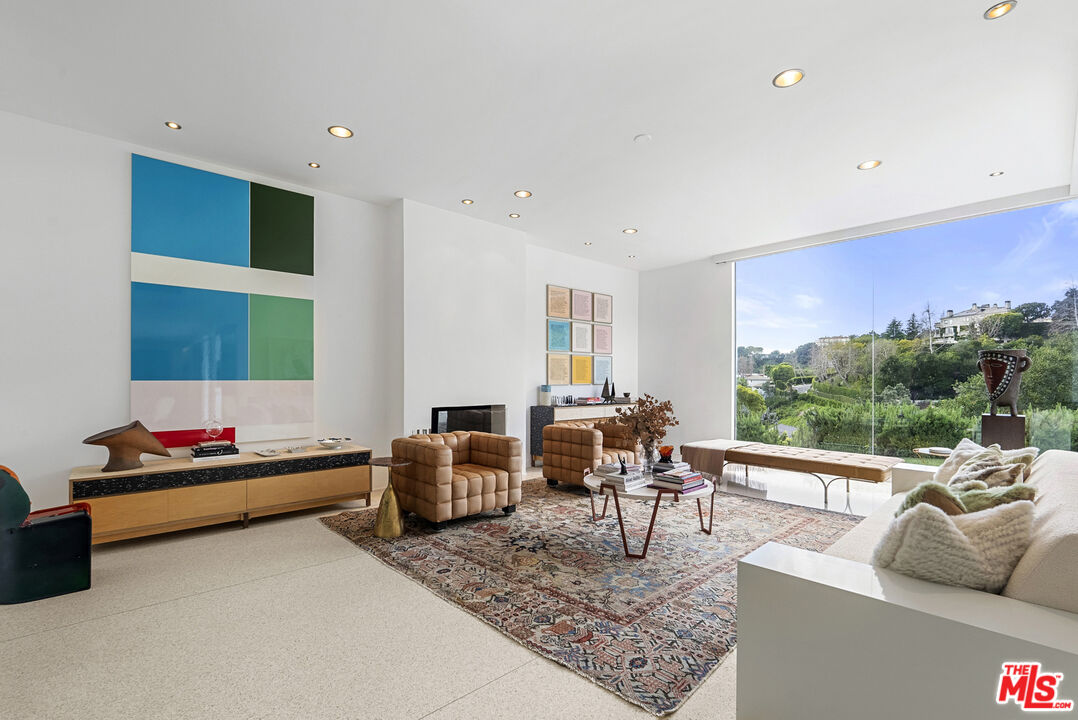 10899 Chalon Road Los Angeles, CA 90077 - Photo 10 of 34 a living room with furniture and a large window