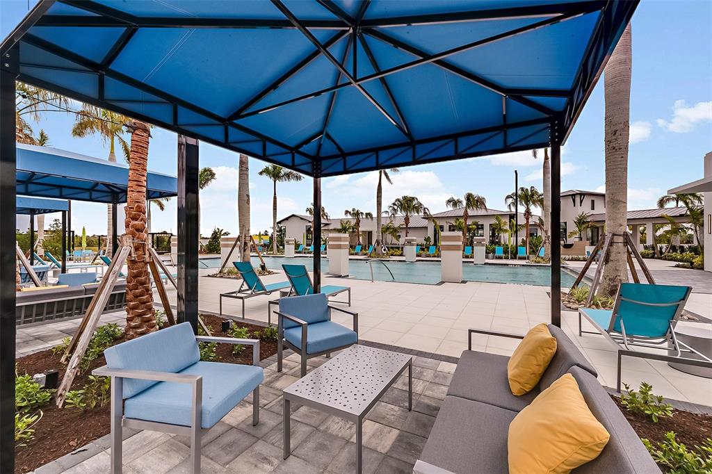 11439 Boundless Terrace Venice, FL 34293 - Photo 37 of 41 a outdoor space with patio the couches and pool table and chairs under an umbrella