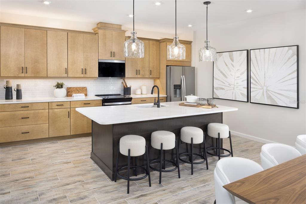 11439 Boundless Terrace Venice, FL 34293 - Photo 7 of 41 a kitchen with granite countertop a sink dining table and chairs
