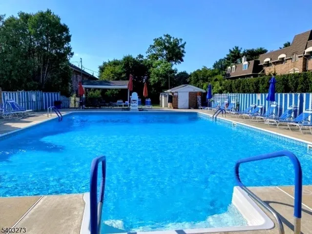 a view of a backyard with couches plants and large tree