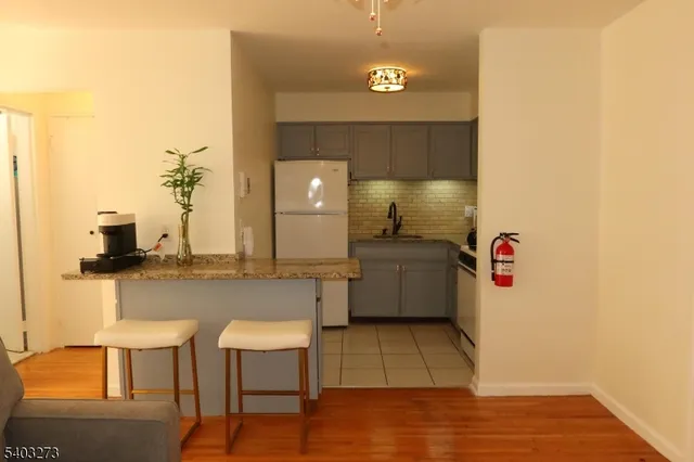 a view of kitchen with furniture and wooden floor