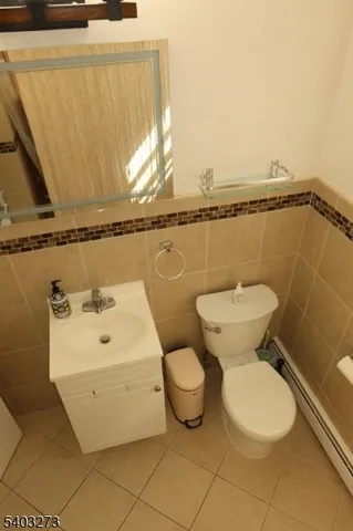 a white toilet sitting next to a bathroom sink