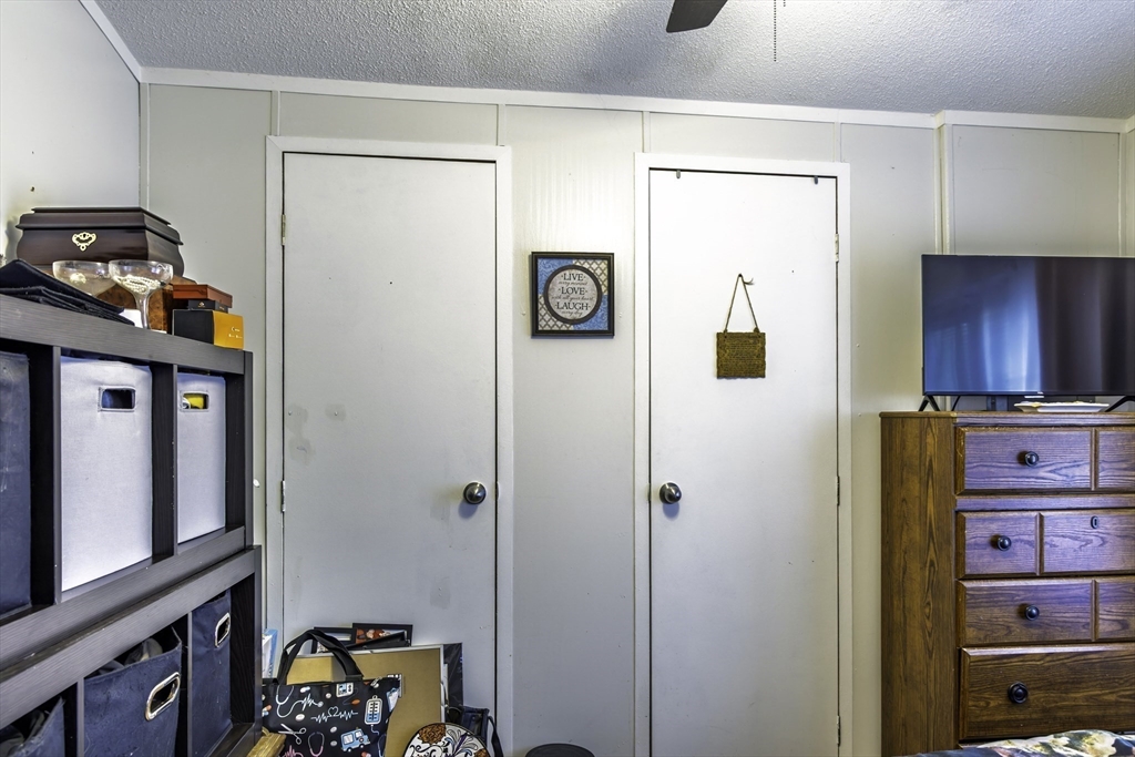 18 Maple Street, Unit 30 Pepperell, MA 01463 - Photo 12 of 19 a view of a hallway to a livingroom with furniture and furniture