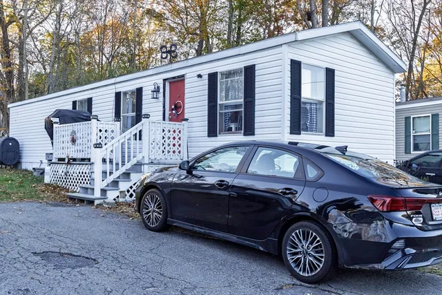 a front view of a house with parking space